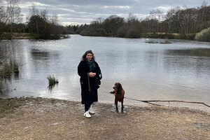 Woman and dog. Body of water in the background.