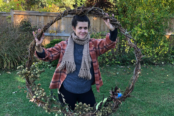 Woman holding large wreath